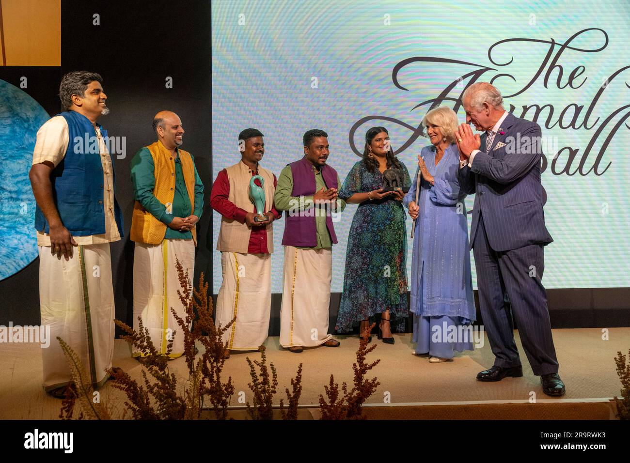 King Charles III and Queen Camilla presents the members of the The Real Elephant Collective, with their Mark Shand Award and Ms Kartiki Gonsalves, with the Tara Award at the Animal Ball at Lancaster House, London, to mark the 20th anniversary of wildlife conservation charity Elephant Family. Picture date: Wednesday June 28, 2023. Stock Photo