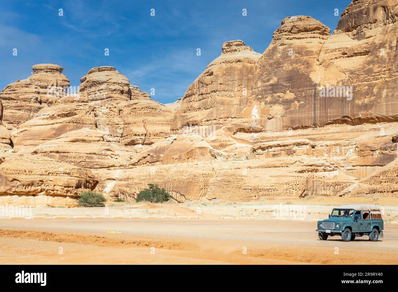 Off-road car and desert cliffs formations landscape at Hegra, Al Ula, Saudi Arabia Stock Photo