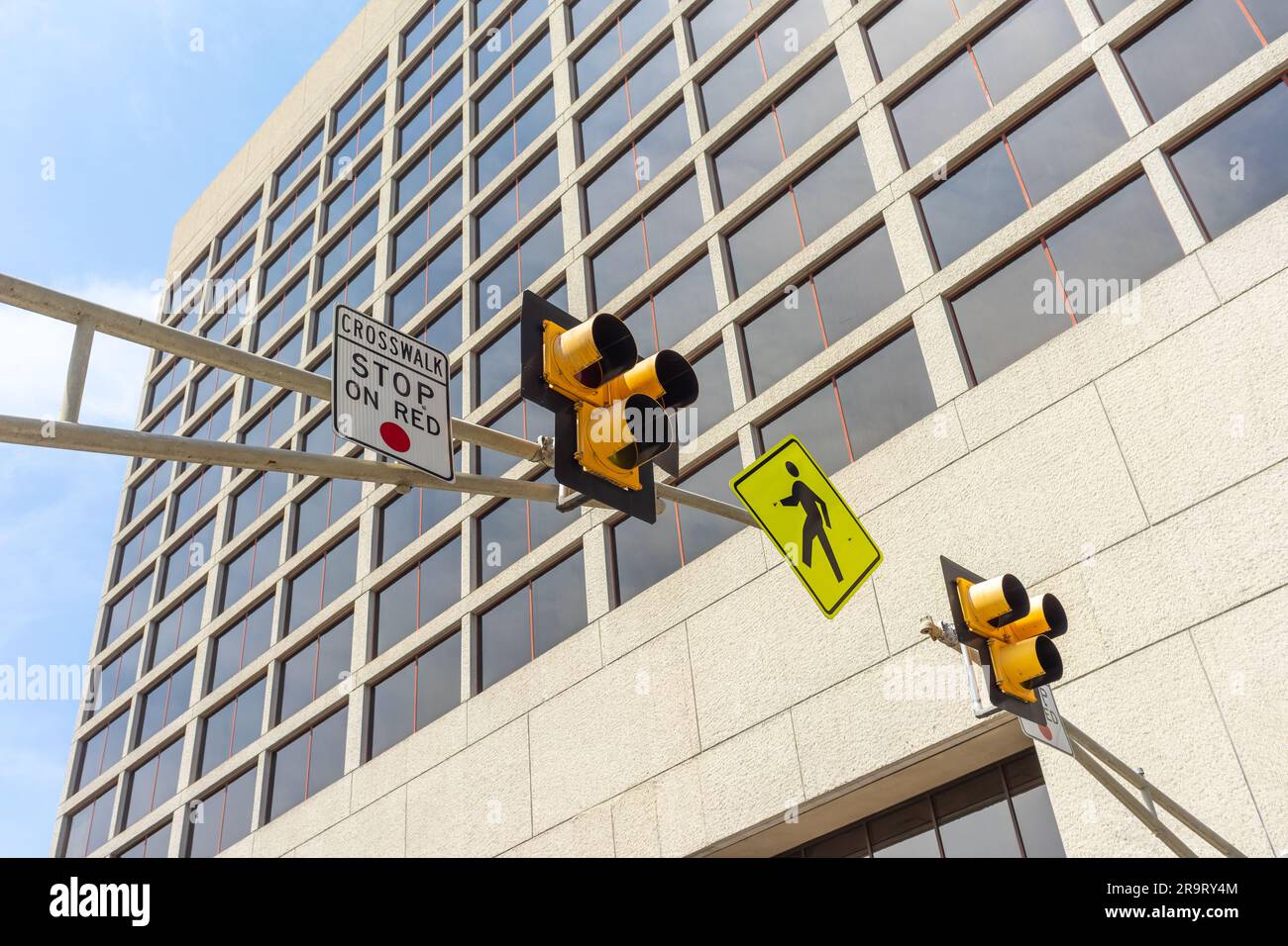 Low angle view of a pedestrian crosswalk traffic signal lights in a city Stock Photo