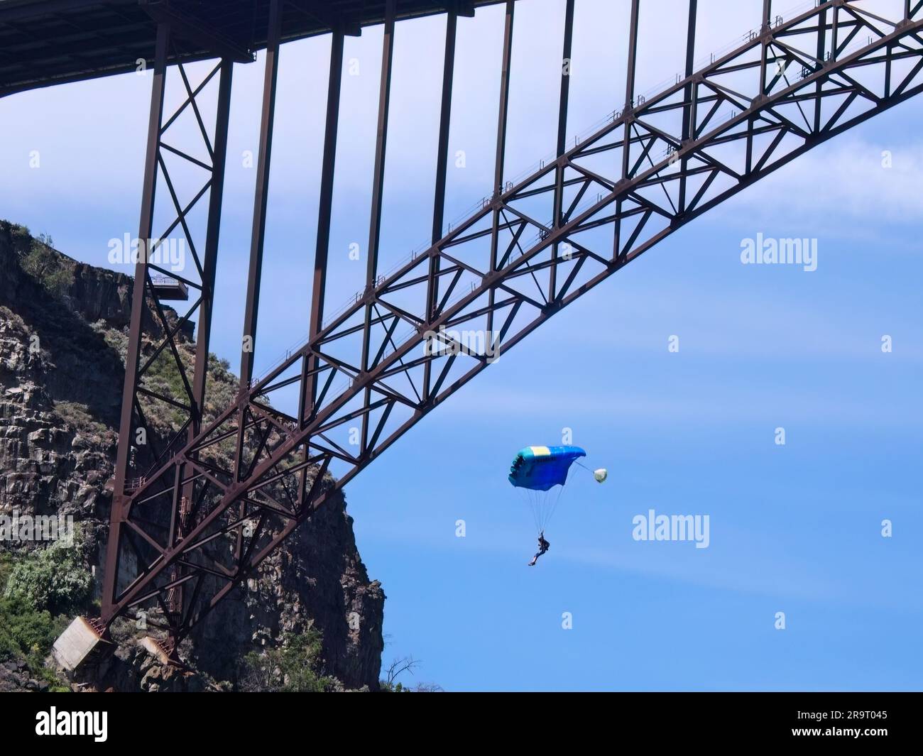 A base jumper glides under his parachute by the Perrine Bridge in Twin