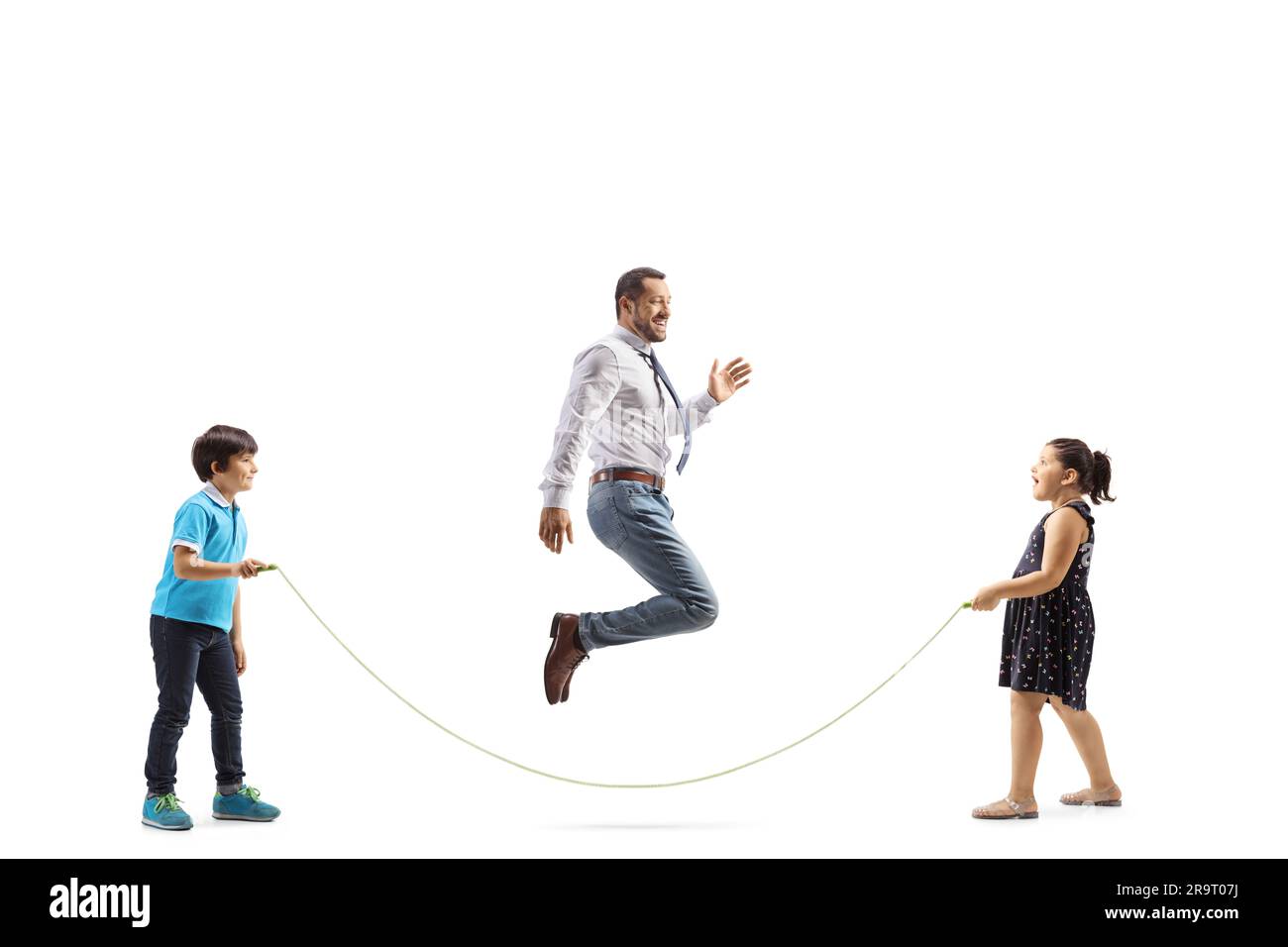Full length profile shot of children holding a rope and father skipping ...