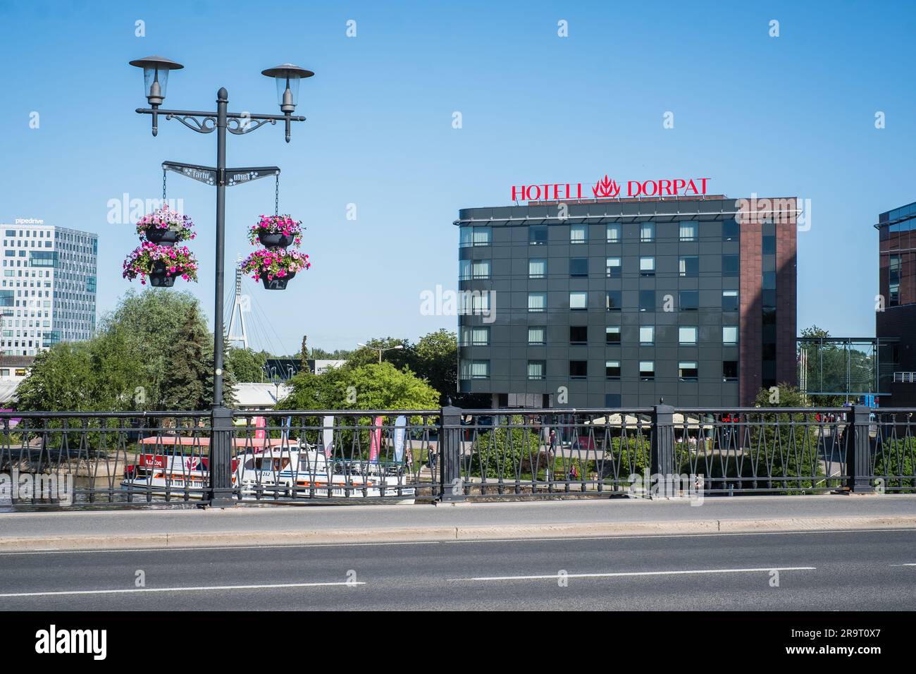 TARTU, Estonia - June 10, 2023: Hotel Dorpat seen across the river. Accommodation in Tartu. Stock Photo