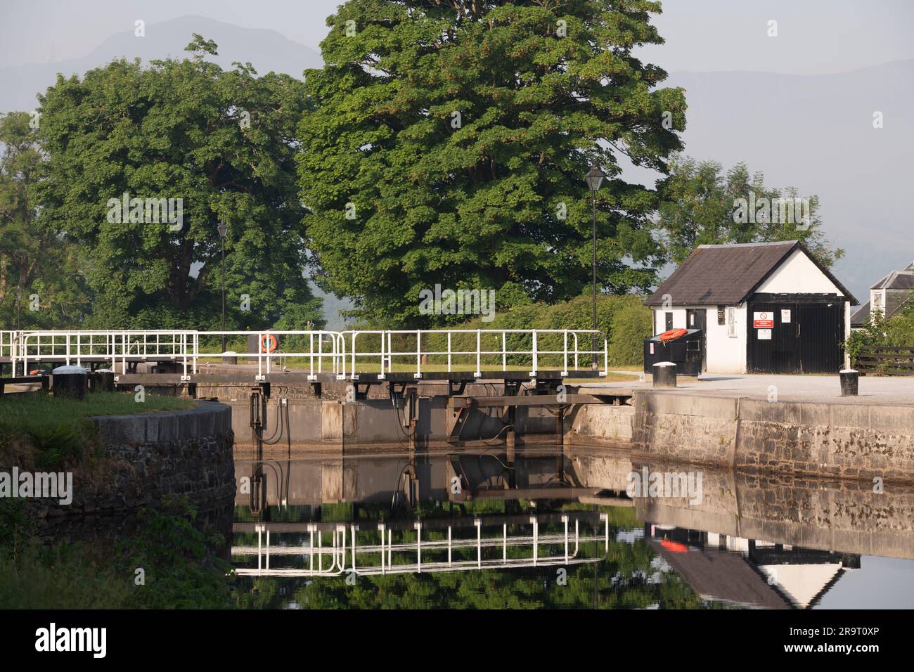 The Top Basin on the Caledonian Canal at Banavie, Near Fort William, with The Lock-gate at The Entrance to Neptune's Staircase on a Summer Morning Stock Photo