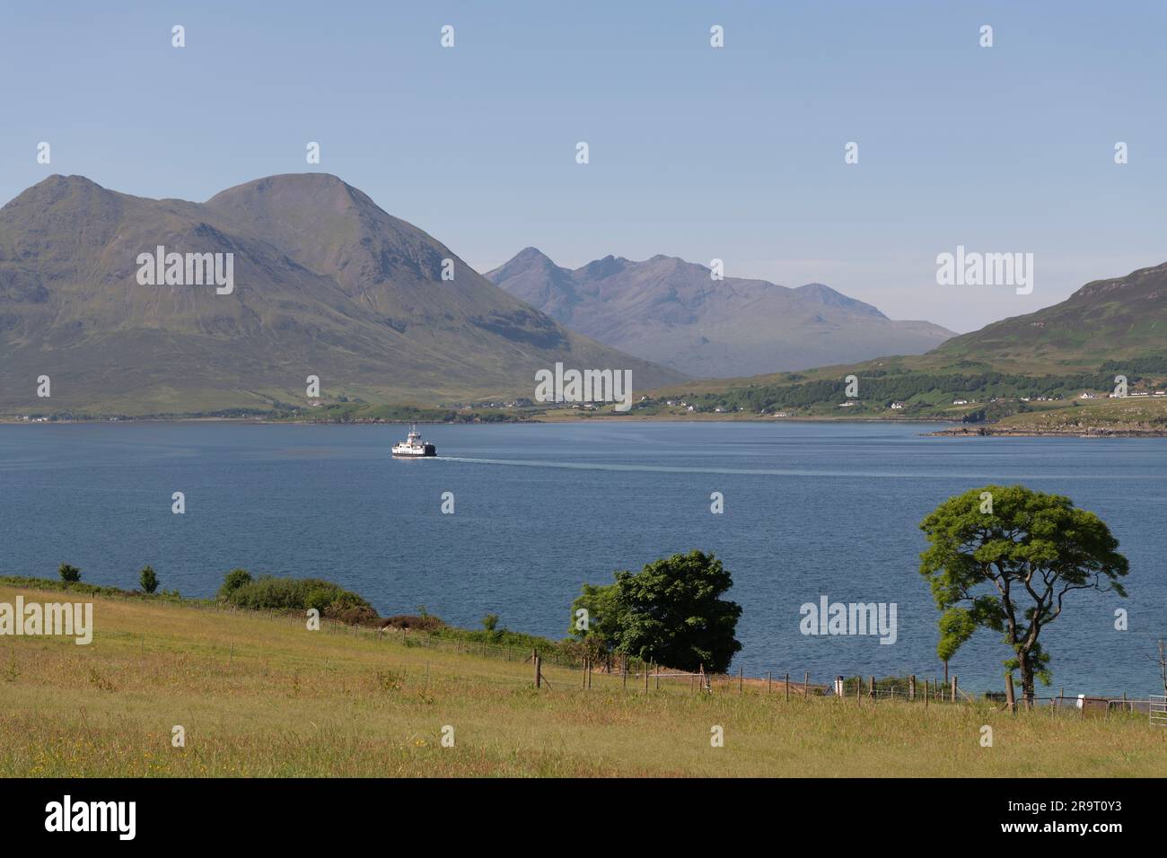 Looking Across the Sound of Raasay Towards Glamaig & Sgurr Nan Gillean on Skye on a Sunny Summer Morning, with the CalMac Ferry Heading to Sconser Stock Photo