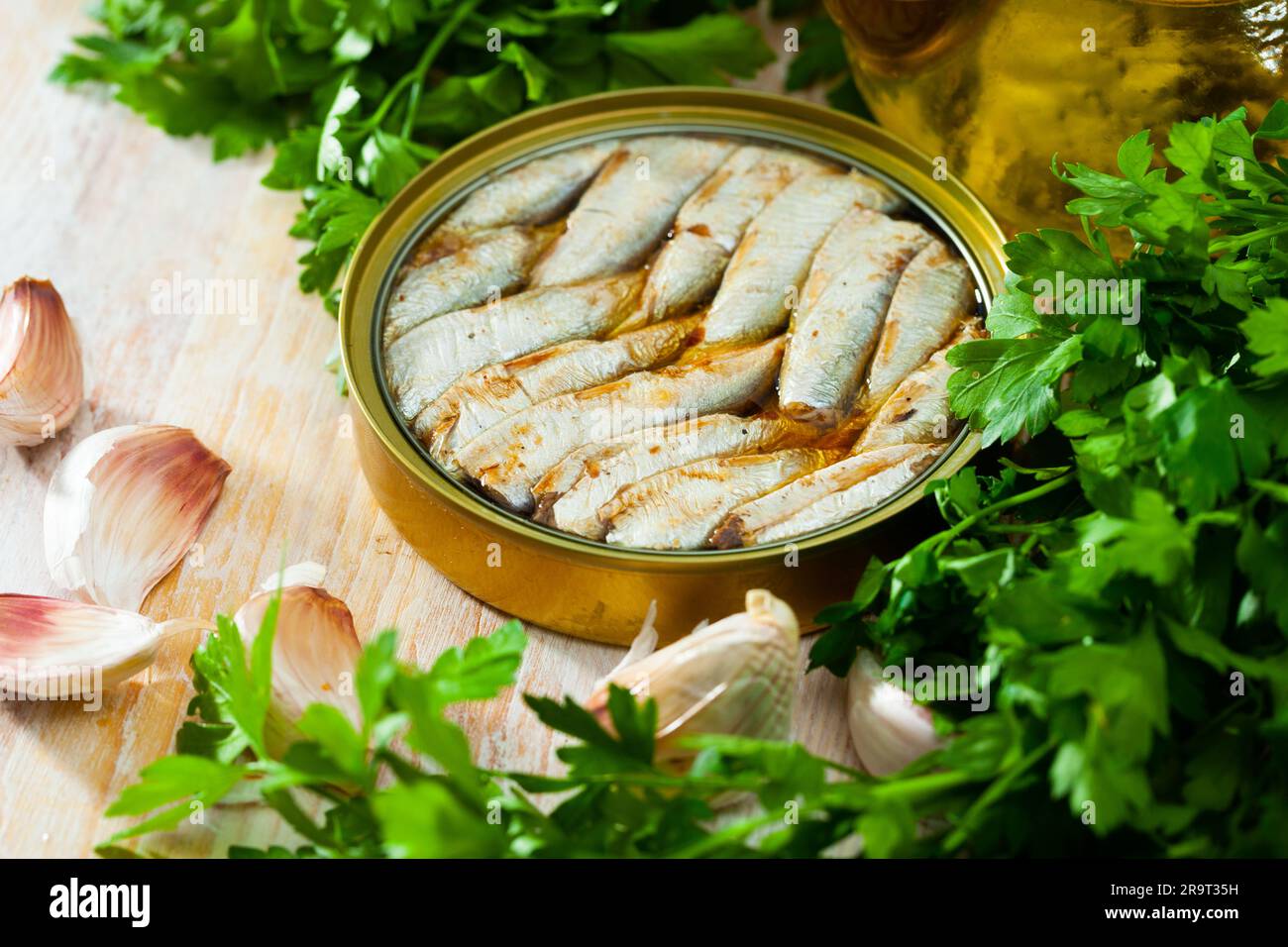 Canned small sardines in oil on background with greens Stock Photo Alamy