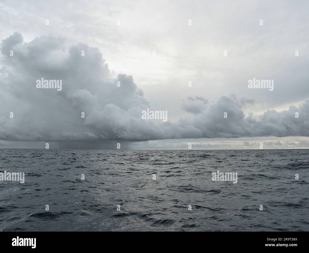 Heavy rain clouds over the ocean, doldrums / ITCZ, Atlantic ocean. Stock Photo