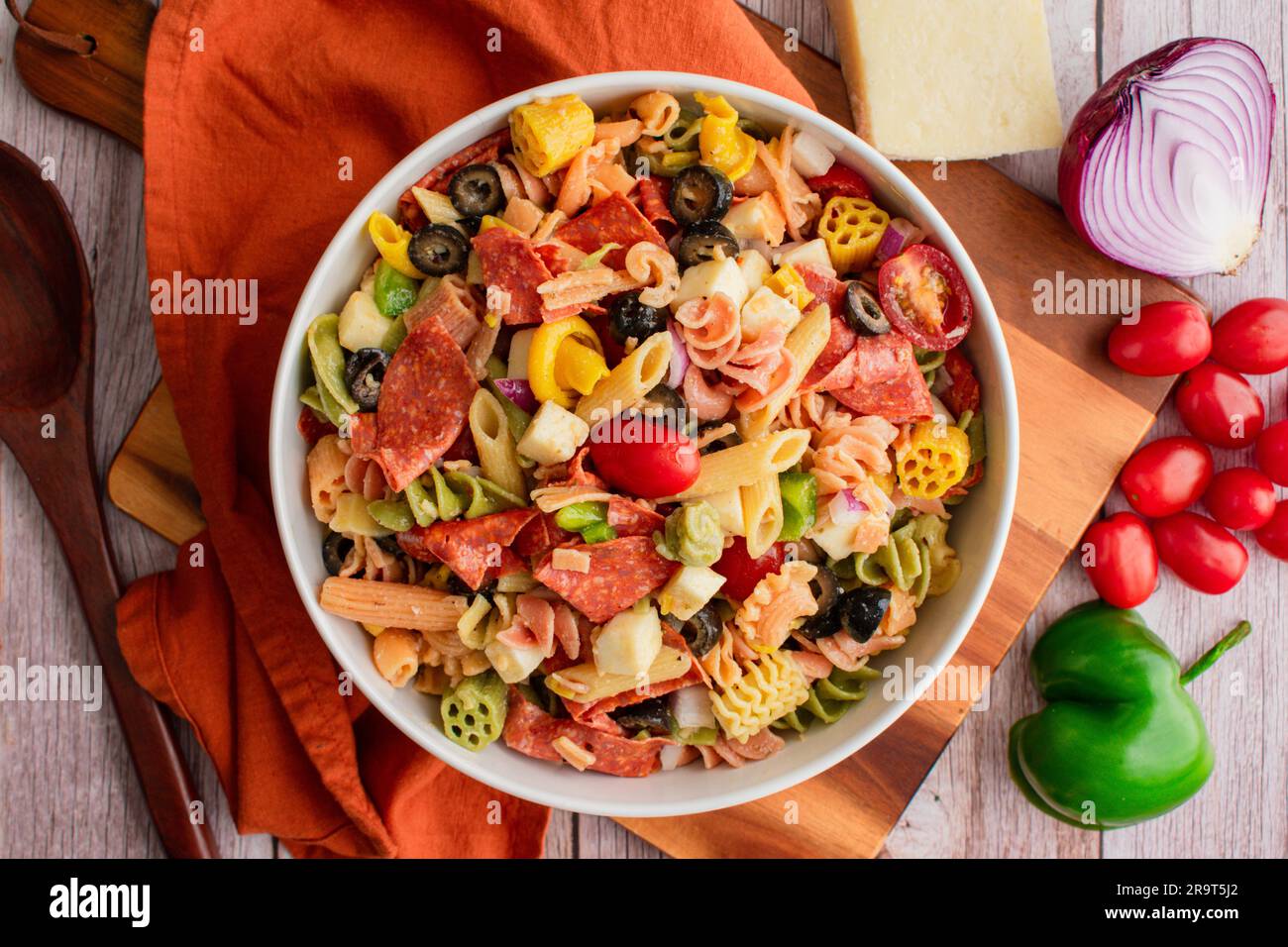 Tricolor Pasta Salad with Vegetables, Cheese, and Pepperoni: Pasta salad with grape tomatoes, bell pepper, red onion, and more Stock Photo