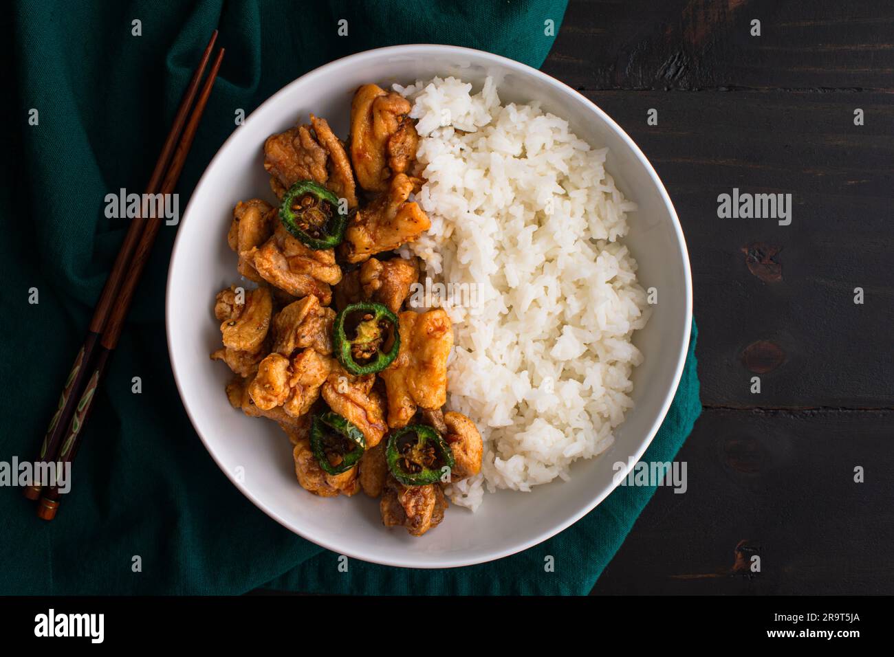 Crispy Hawaiian Garlic Chicken Served with Jasmine Rice: Fried chicken thighs in garlic-soy sauce served with fried jalapeno peppers and white rice Stock Photo