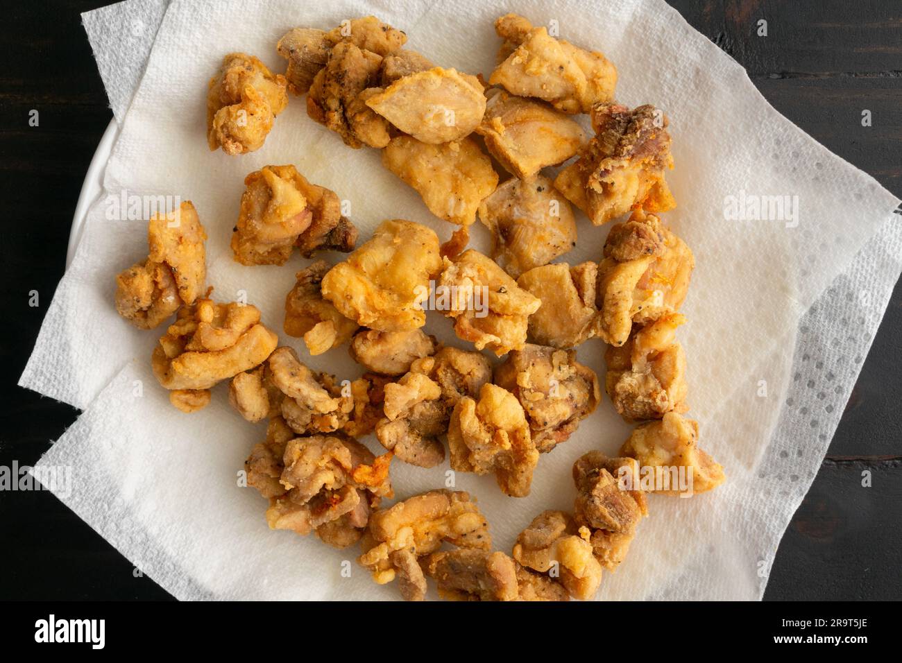 CloseUp of Fried Pieces of Chicken Draining on Paper Towels Deepfried bitesize chicken thigh
