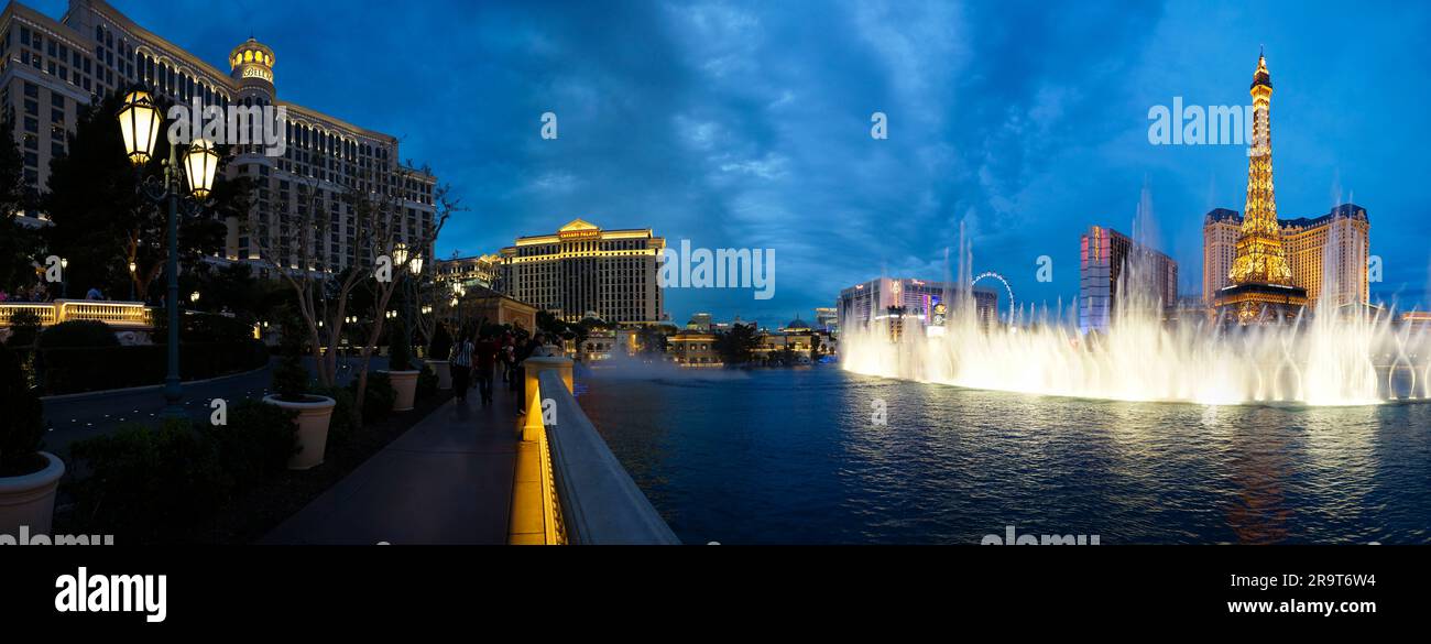Bellagio Fountains and imitation of Eiffel Tower illuminated at dusk, Las Vegas, Nevada, USA Stock Photo