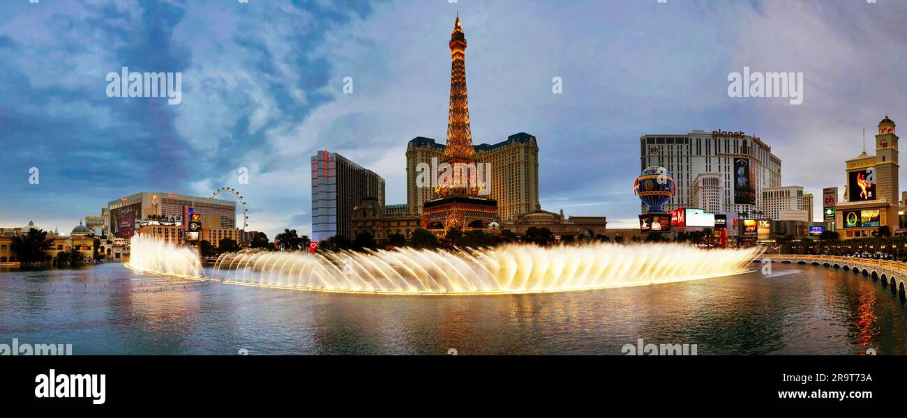 Bellagio Fountains and imitation of Eiffel Tower illuminated at dusk, Las Vegas, Nevada, USA Stock Photo