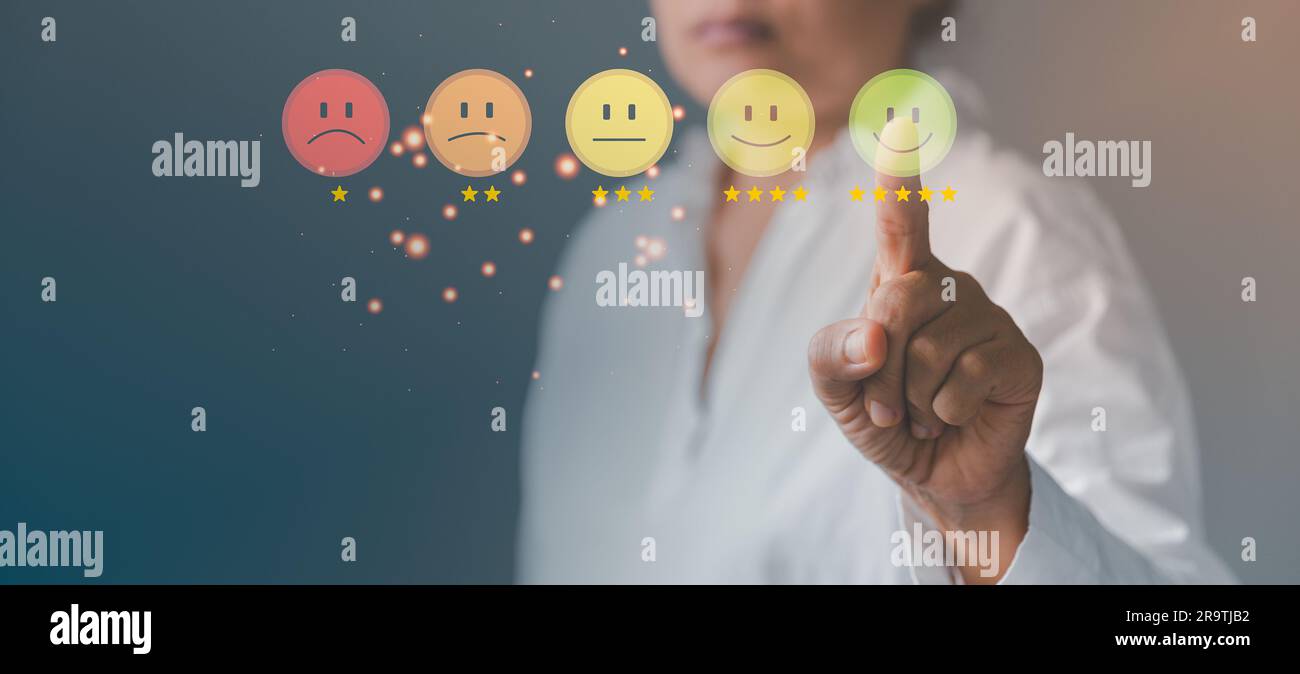 Business person are touching the virtual screen on happy Smiley face icon to give satisfaction in service. Customer service and Satisfaction concept, Stock Photo