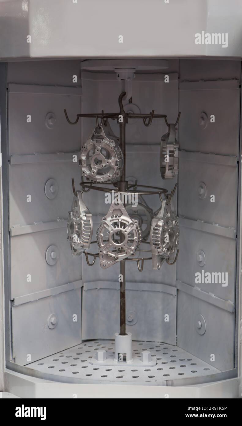 Sand blasting machine. Shot blaster cleaning surface of parts Stock