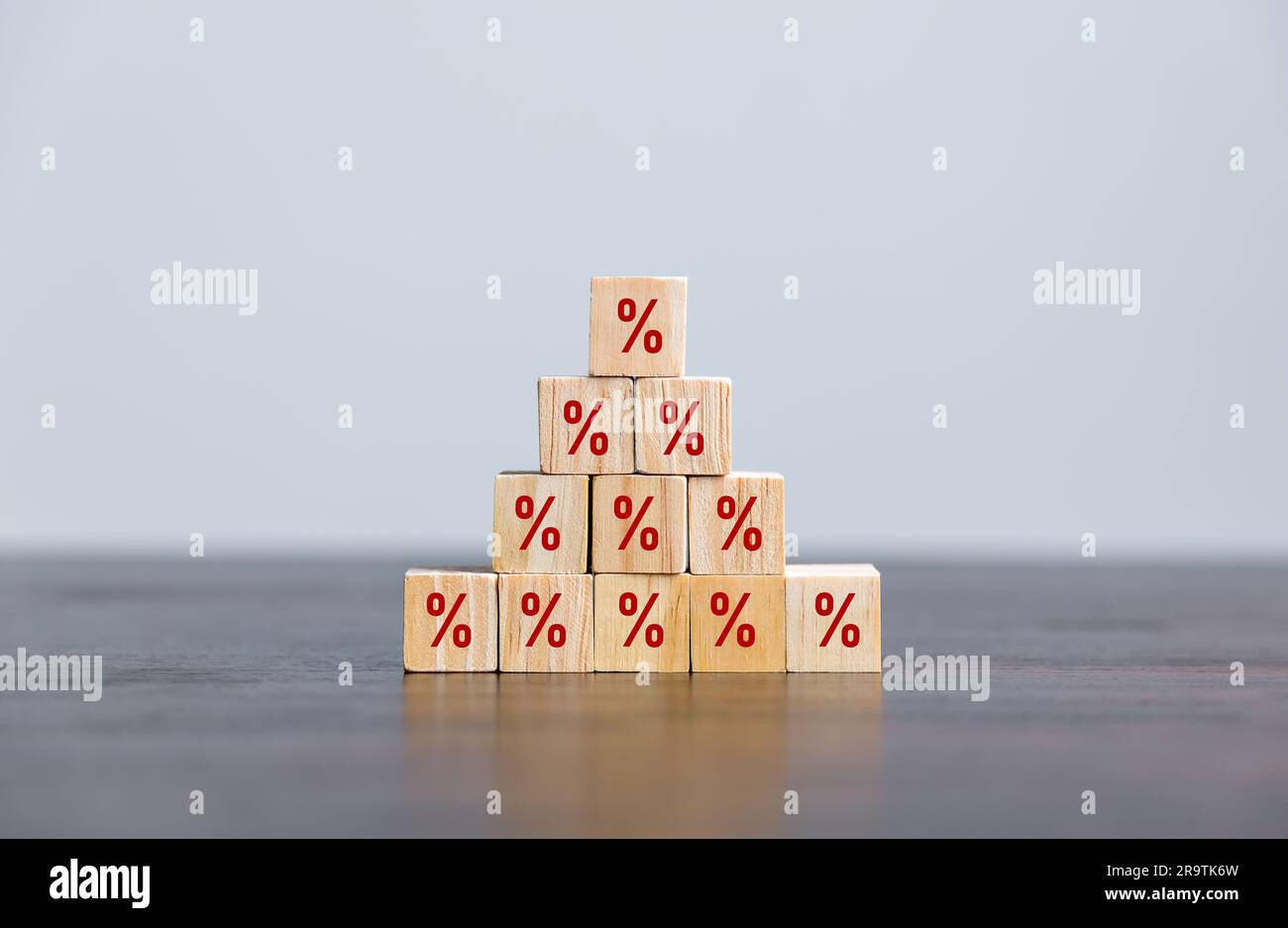 Closeup wood cubes with percentage symbol, business interest, discount investment, financial growth, interest rate increase, sale price and tax rise, Stock Photo