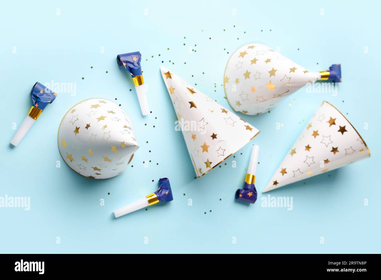 Composition with party hats and whistles on pale blue background Stock ...