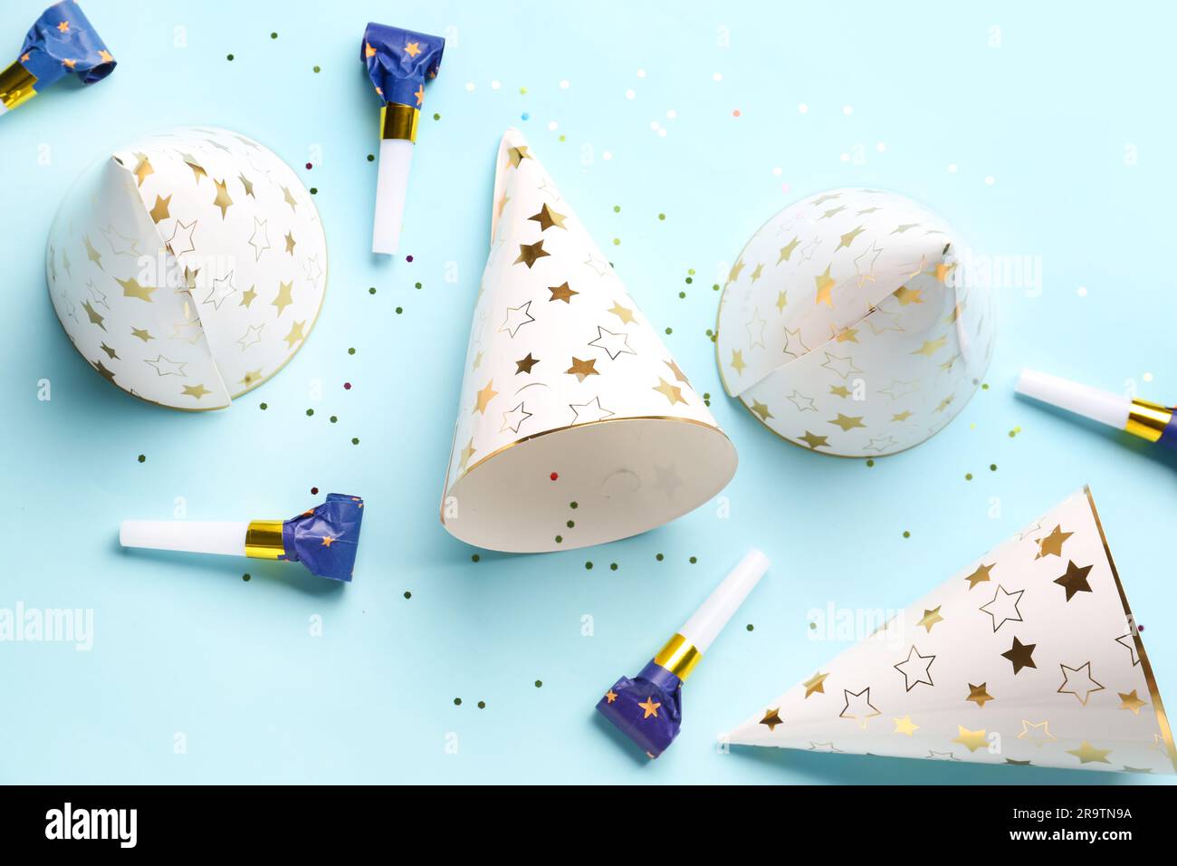 Composition with party hats and whistles on pale blue background Stock ...