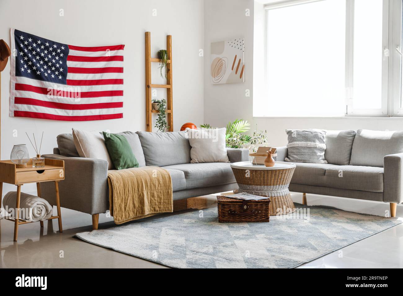 Interior of stylish living room with hanging USA flag Stock Photo - Alamy
