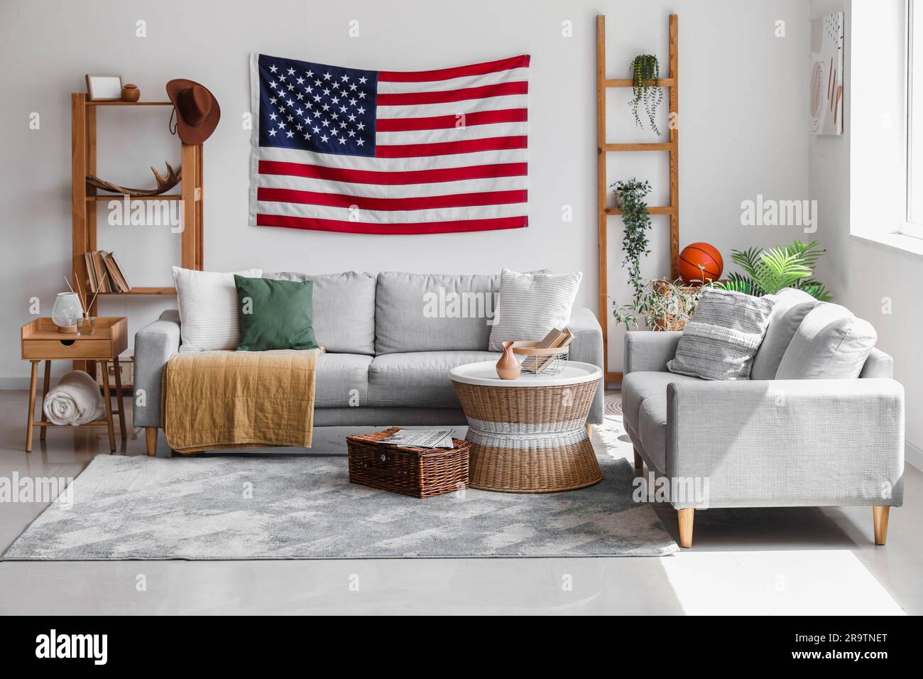 Interior of stylish living room with hanging USA flag Stock Photo - Alamy