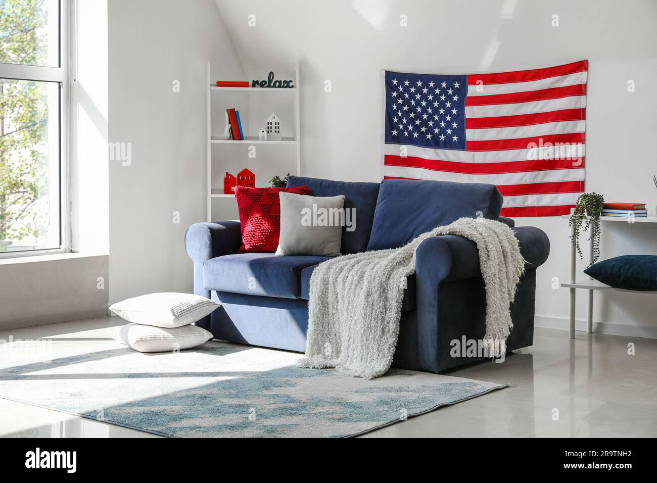 Interior of modern living room with hanging USA flag Stock Photo - Alamy