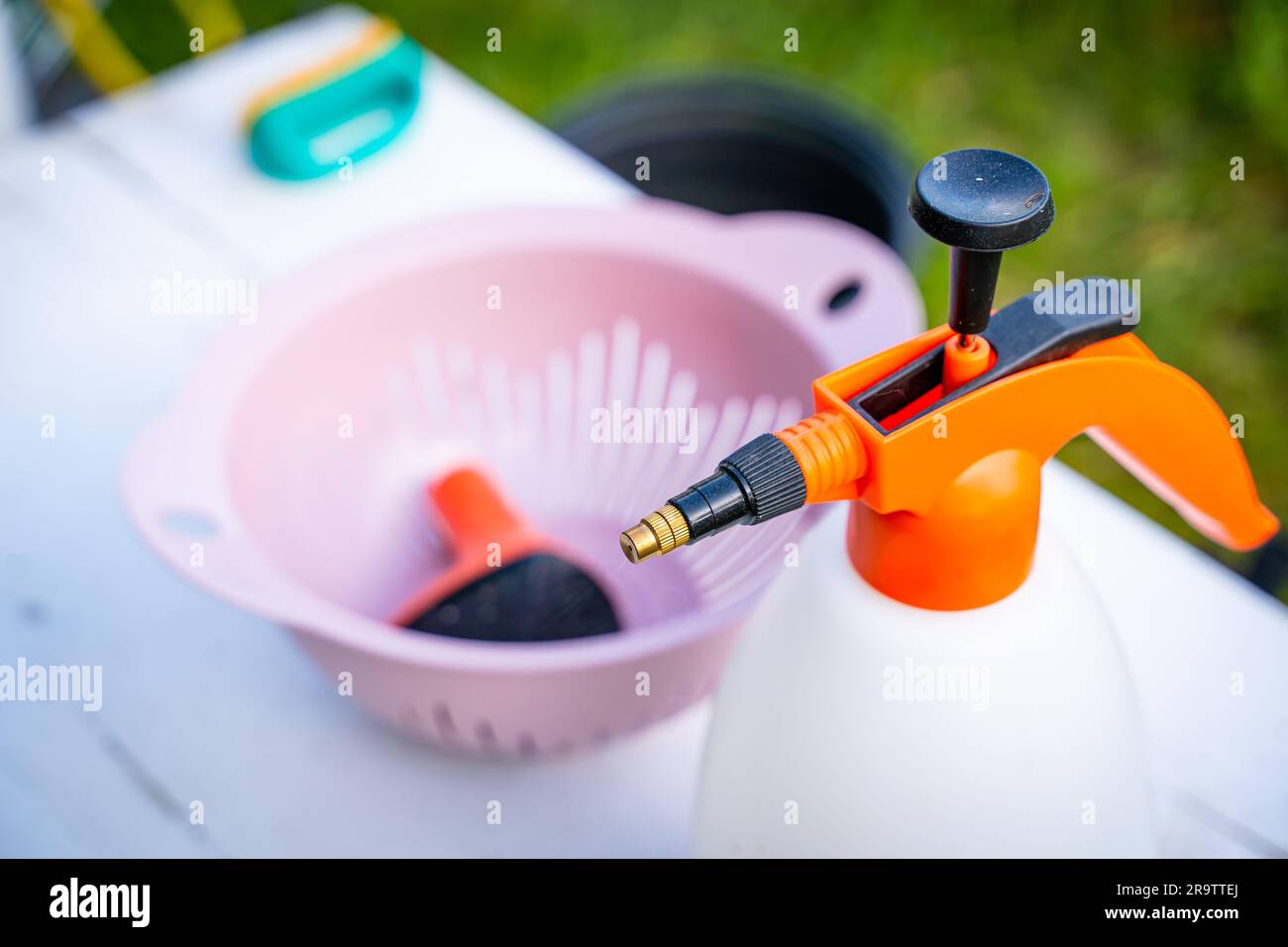 Garden pump sprayer with orange handle closeup. Universal garden
