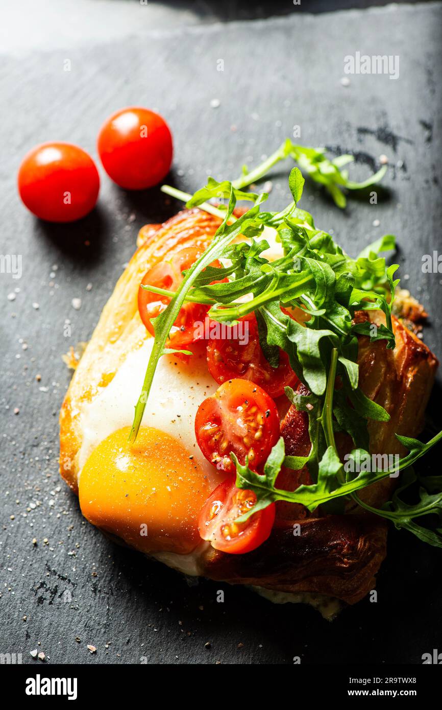 Homemade savoury breakfast Danish with a free-range egg, cherry ...