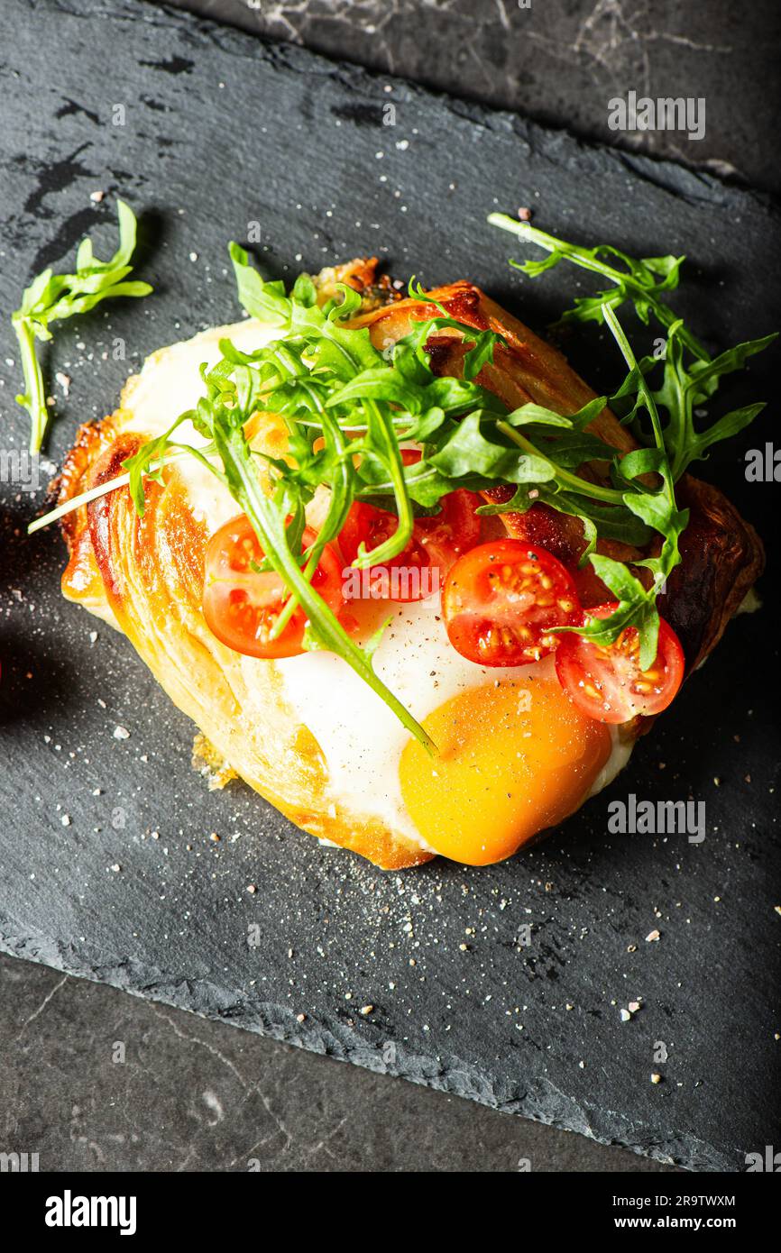 Homemade savoury breakfast Danish with a free-range egg, cherry ...