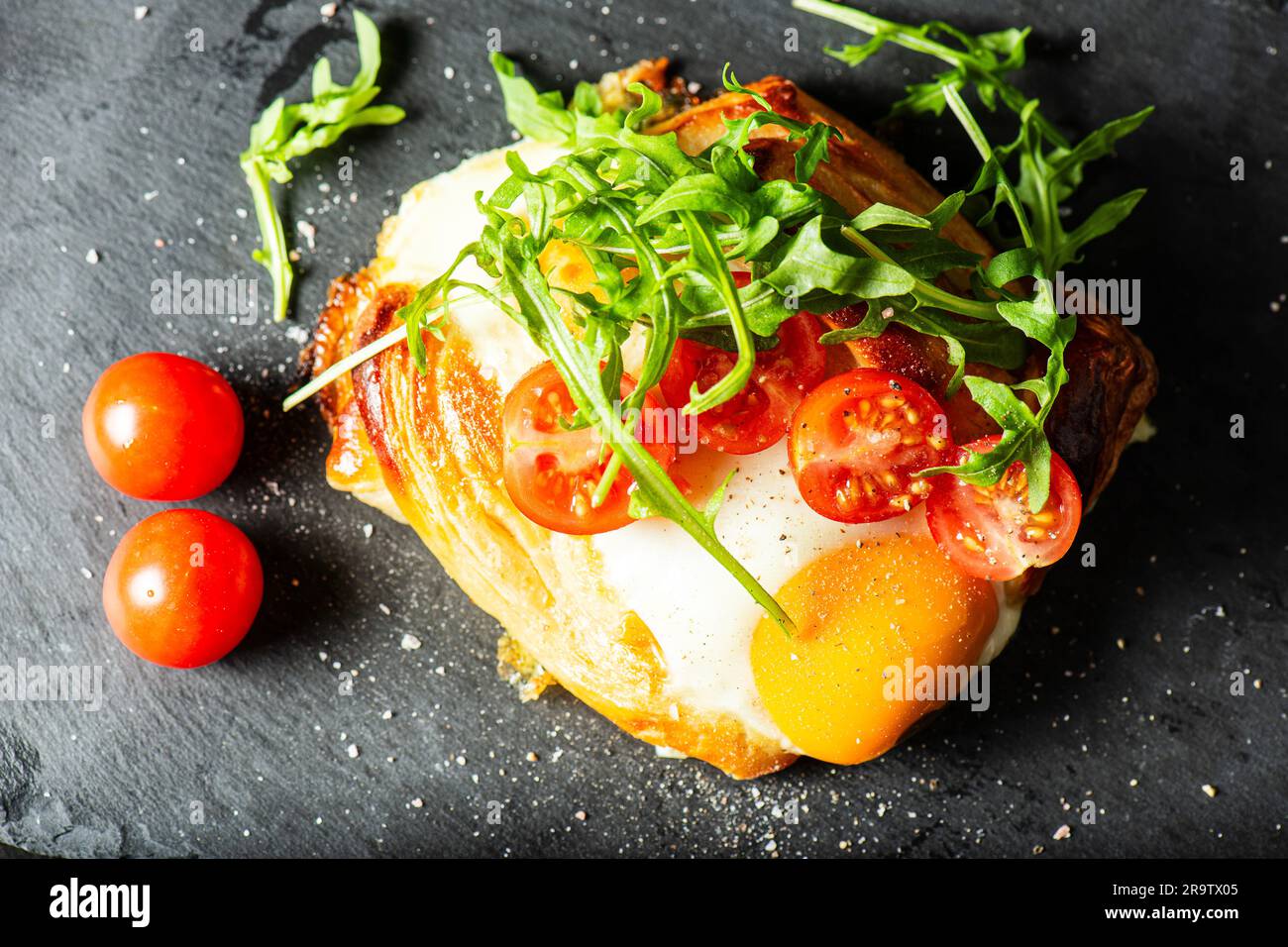 Homemade savoury breakfast Danish with a free-range egg, cherry ...