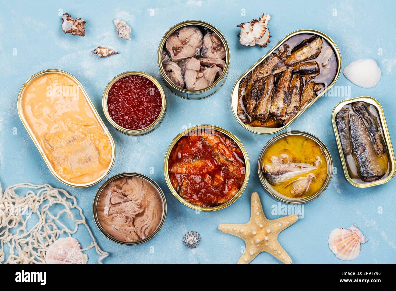 Variety of opened tins with different types of canned fish and seafood. Natural source of omega