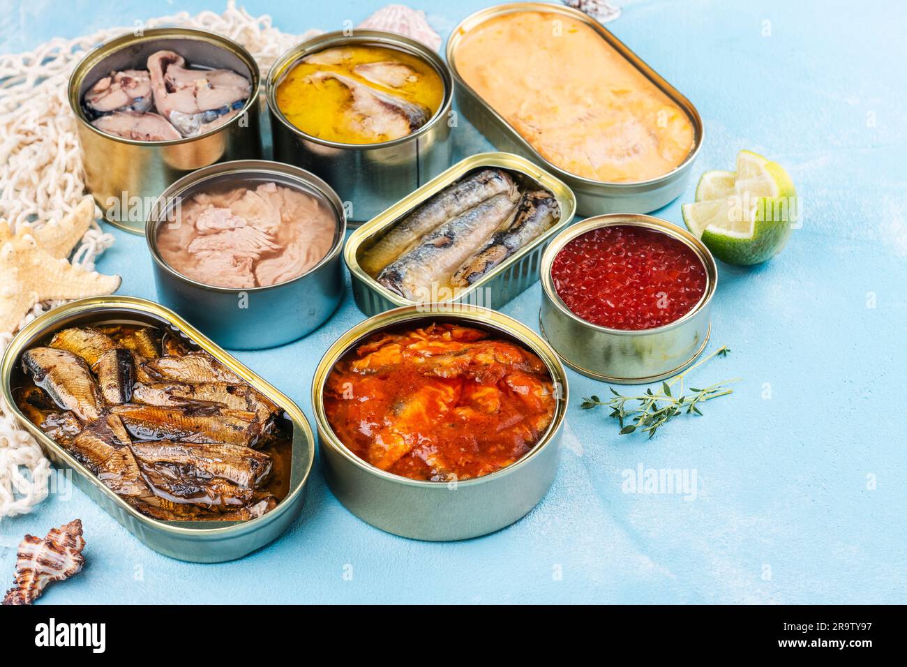 Variety of opened tins with different types of canned fish and seafood