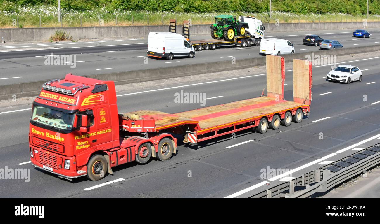 Volvo hgv semi lorry truck raised economy axle by Telescopic Heavy Haulage business low loader trailer traveling empty on M25 motorway road England UK Stock Photo