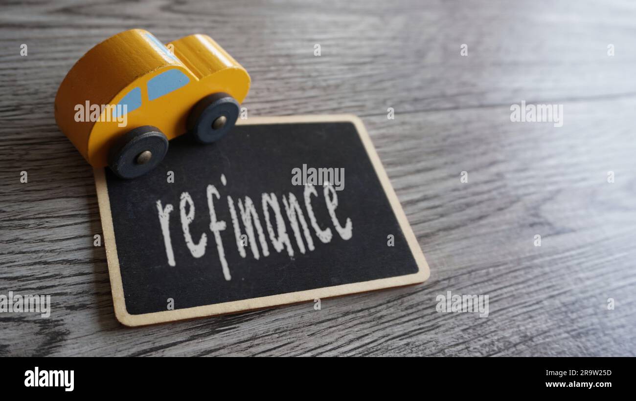 Toy car and text REFINANCE with copy space. Car loan refinancing concept Stock Photo