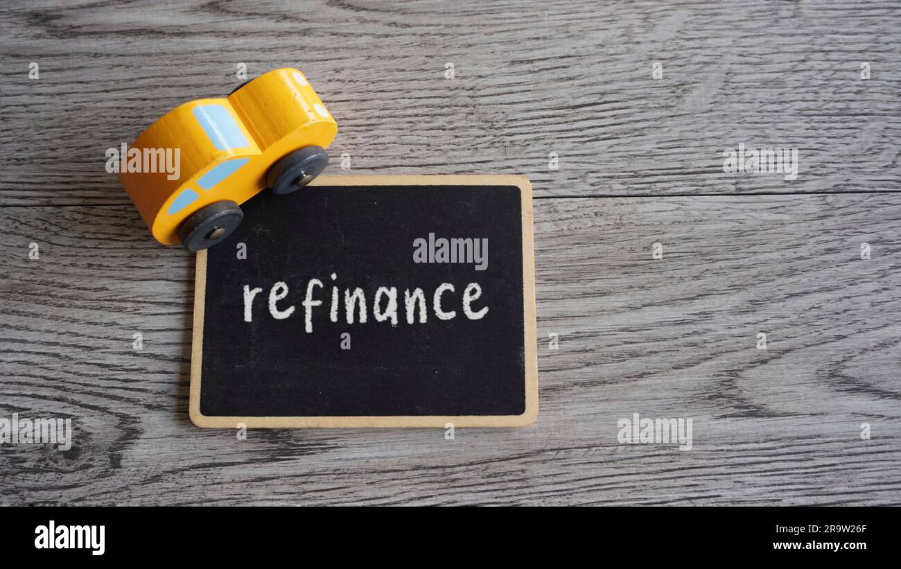 Toy car and text REFINANCE with copy space. Car loan refinancing concept Stock Photo