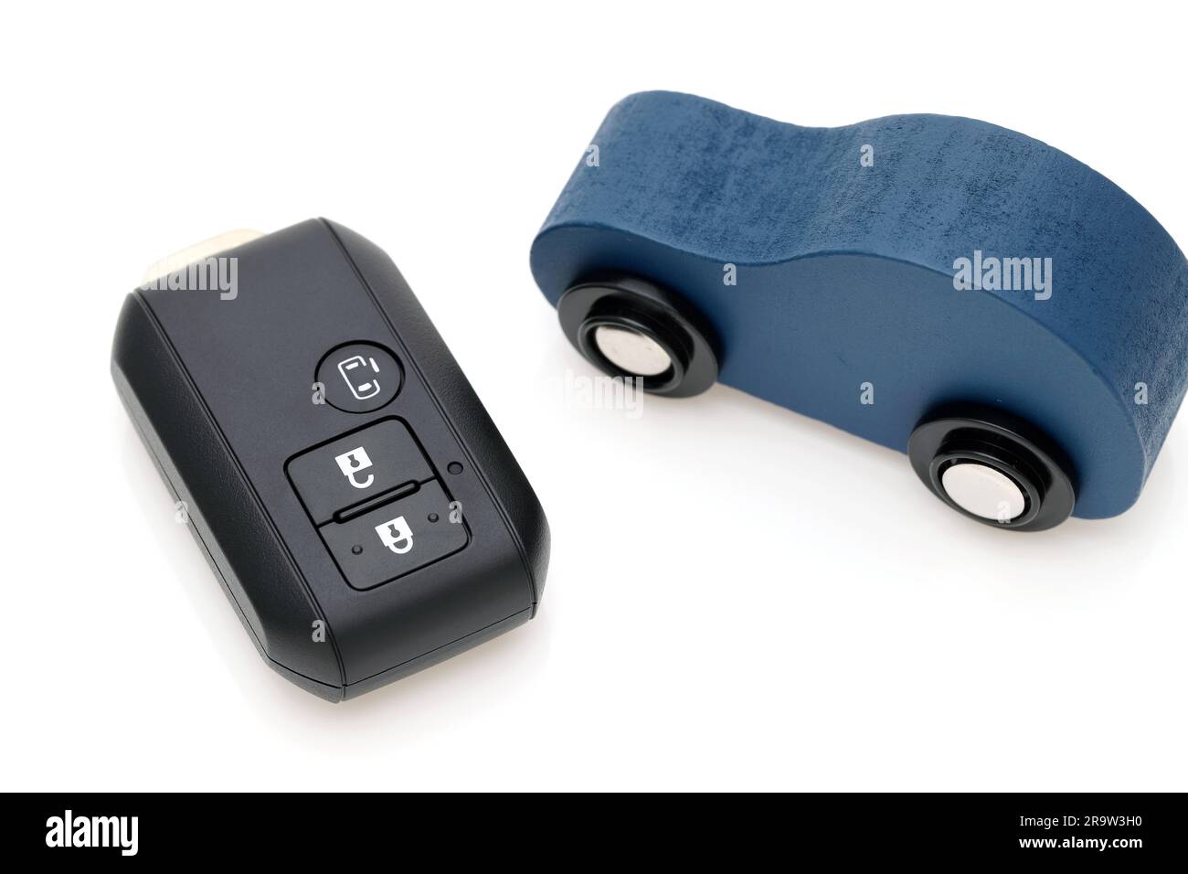 Car black key remote controller and small toy car on white background Stock Photo