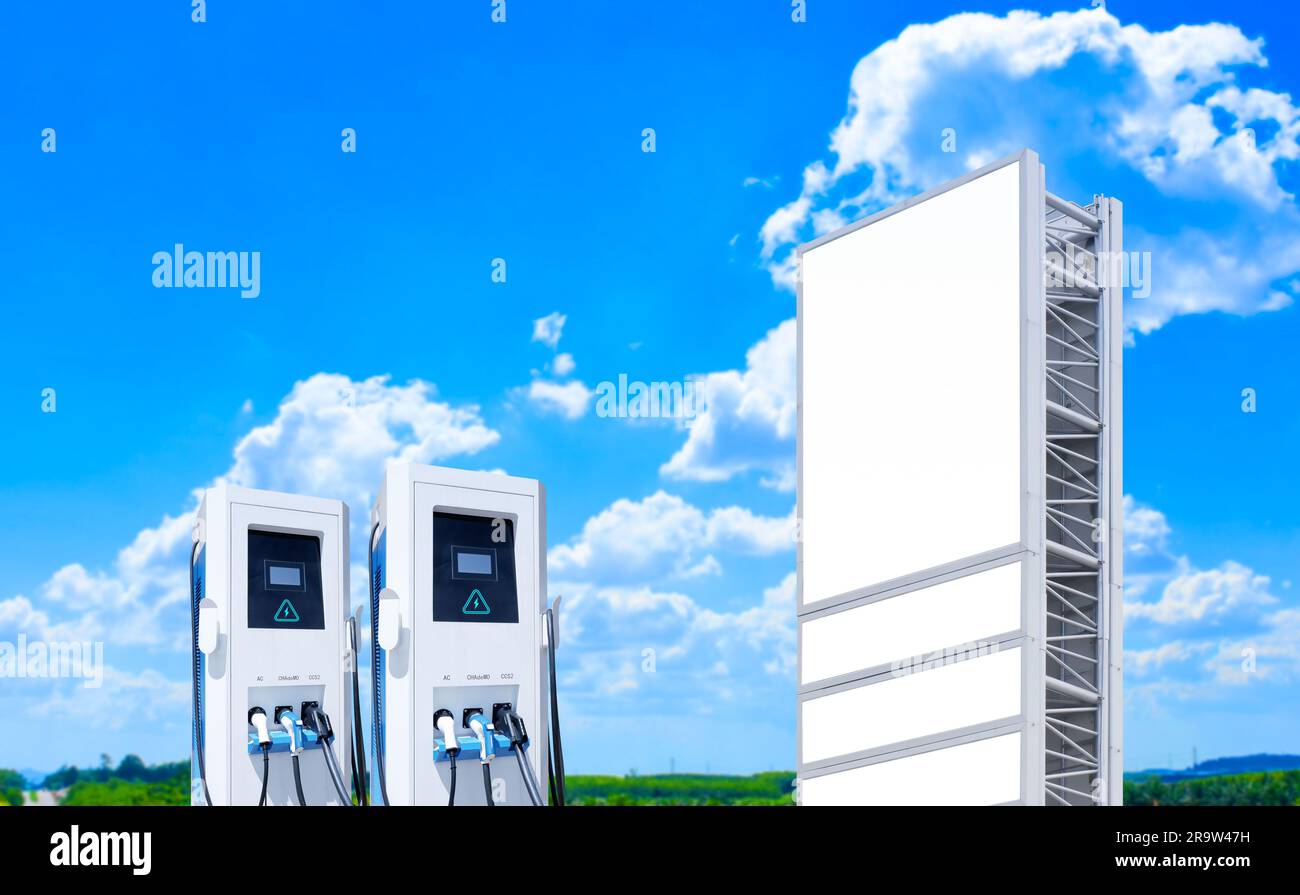 Electric car charging station with blank billboard on blue sky and
