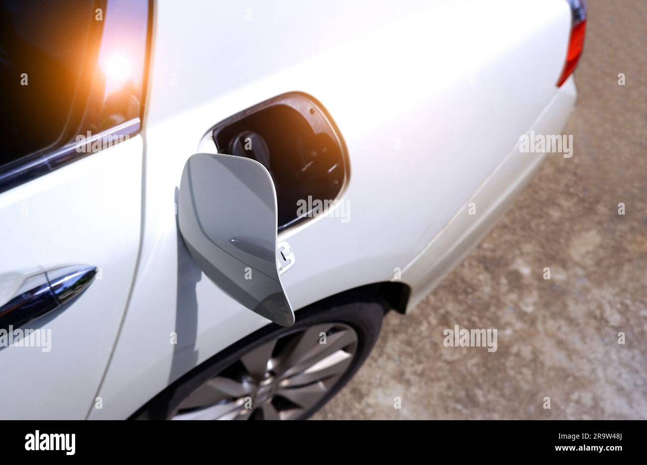 The car fuel tank cap is opened to fill with fuel. Stock Photo