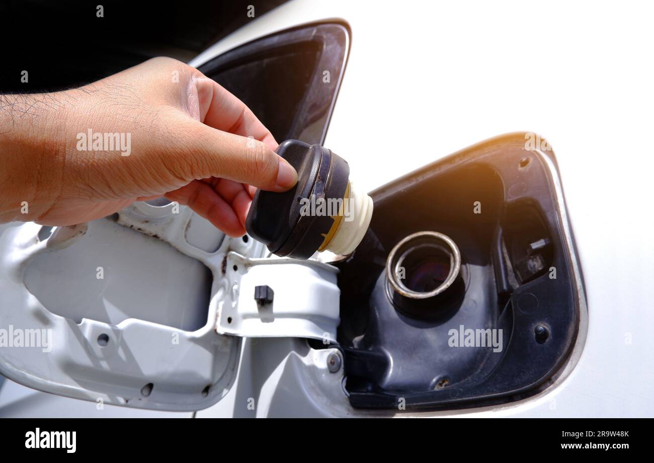 Closeup of a man hand opening the gas tank of a car for refueling. Stock Photo