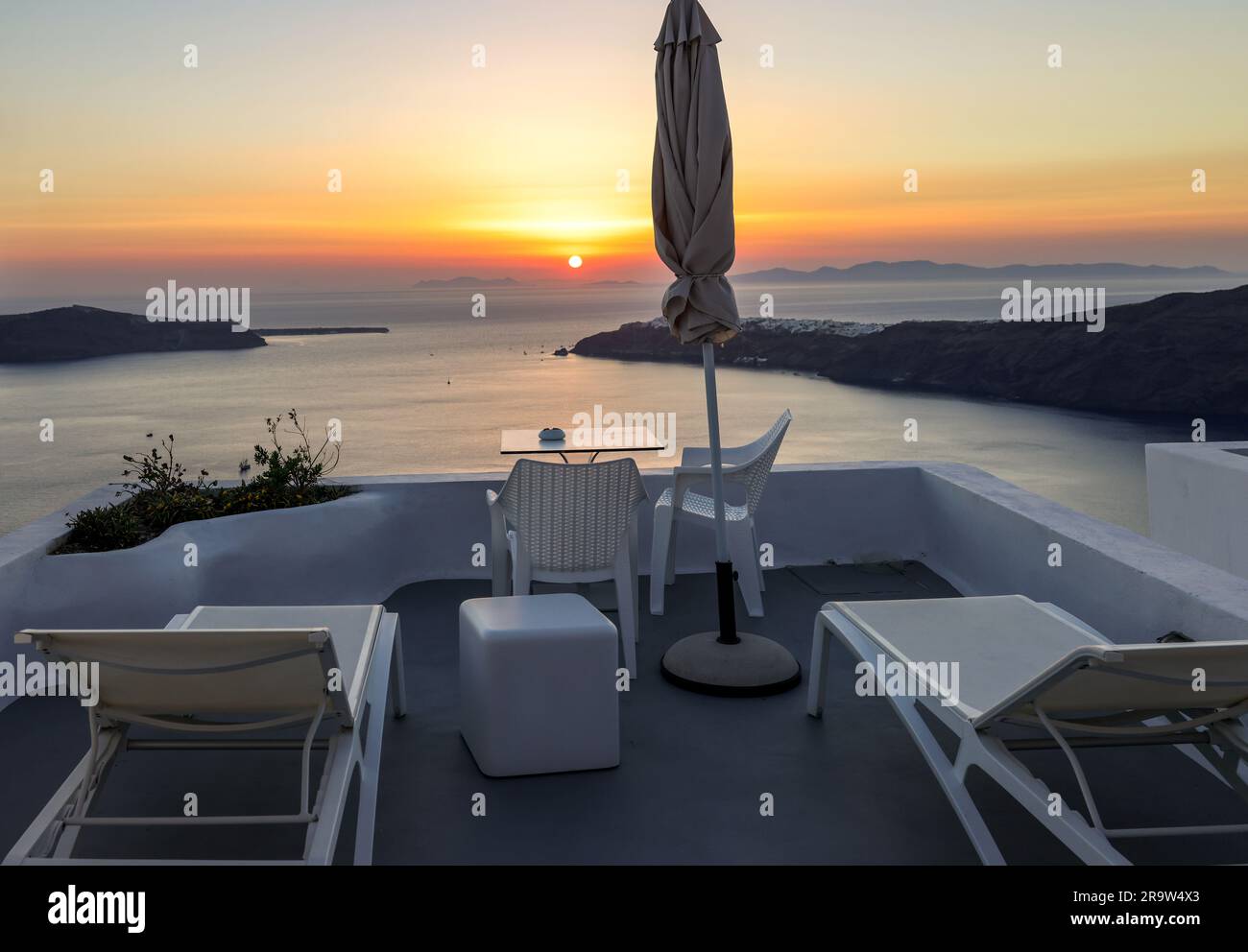 Terrace In The Village Of Imerovigli With Amazing View Of Sunset Over terrace-in-the-village-of-imerovigli-with-amazing-view-of-sunset-over