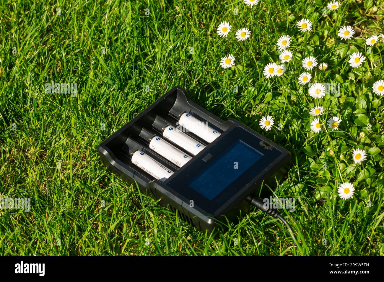 Black AA battery charger with rechargeable alkaline batteries on the