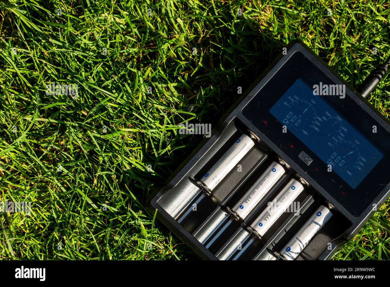 Black AA battery charger with rechargeable alkaline batteries on the