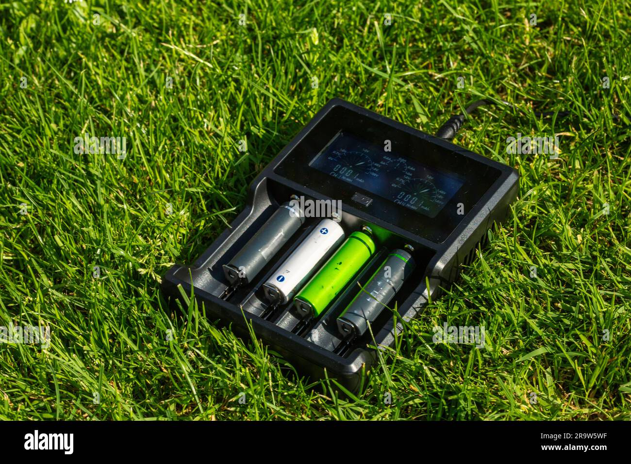 Black AA battery charger with rechargeable alkaline batteries on the