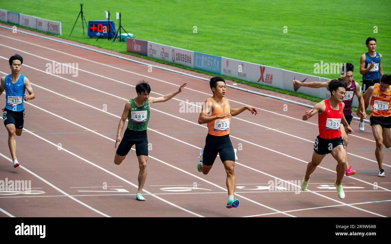 SHENYANG, CHINA - JUNE 29, 2023 - Runners compete in the men's 200m race during the Hangzhou Asian Games trials in Shenyang, Liaoning province, China, Stock Photo