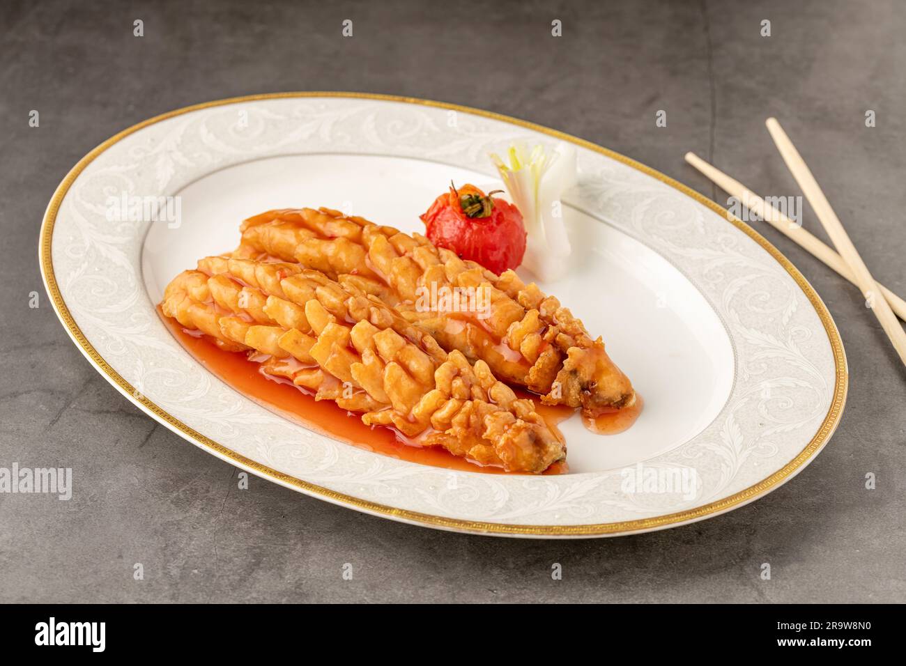 Squirrel fish on a white porcelain plate in a fine dining restaurant Stock Photo
