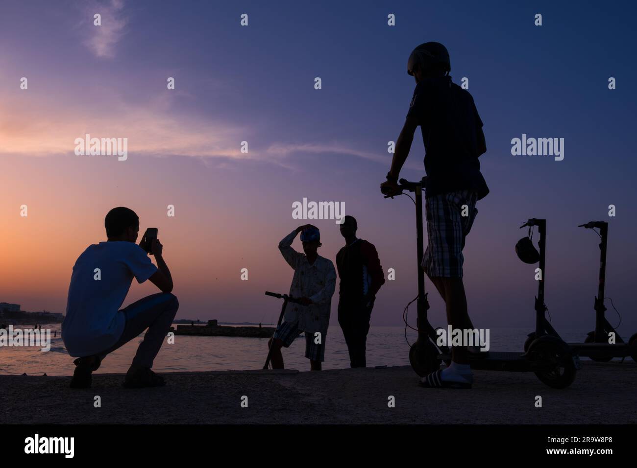 A group of young men on the beach in Sousse at sunset, Tunisia Stock Photo