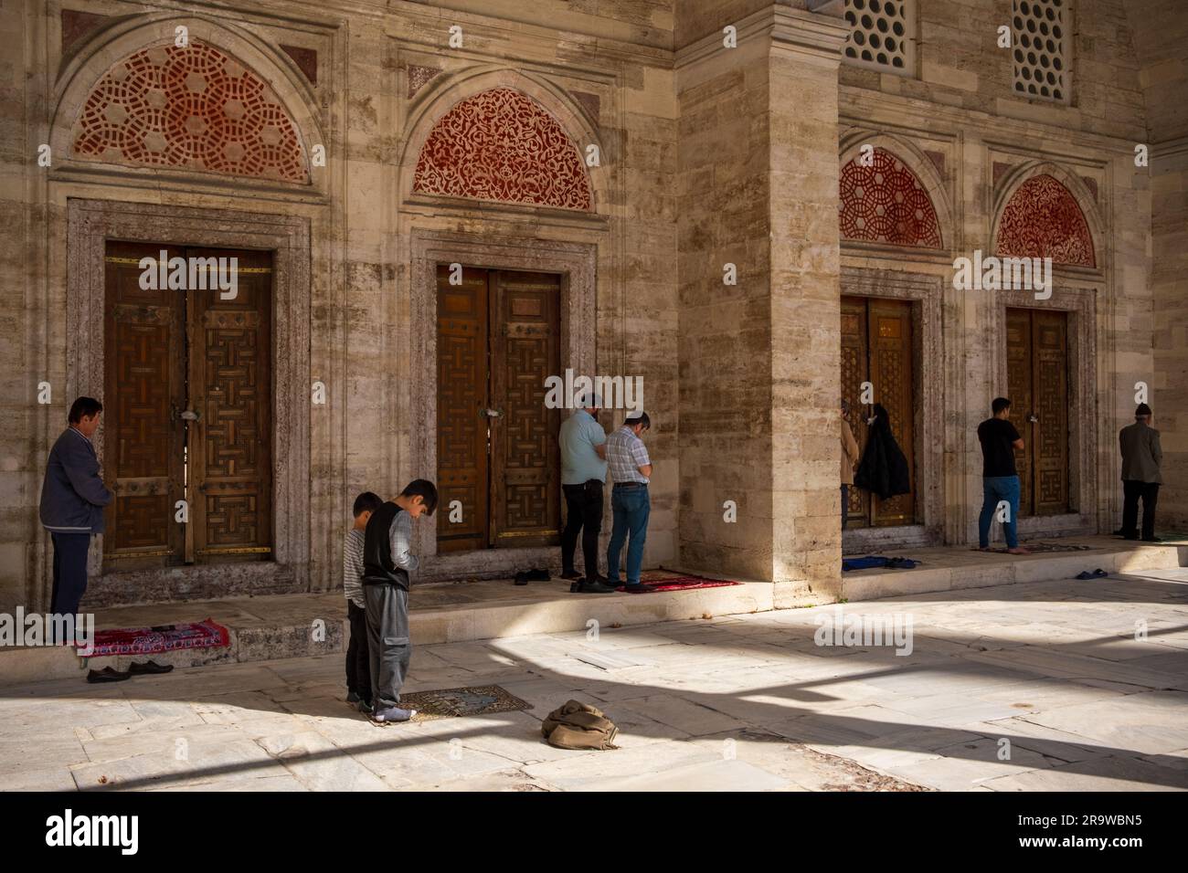 People pray in a mosque in Istanbul Stock Photo