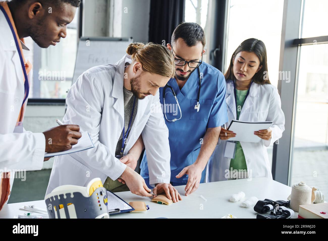young student making injection in training pad near medical equipment