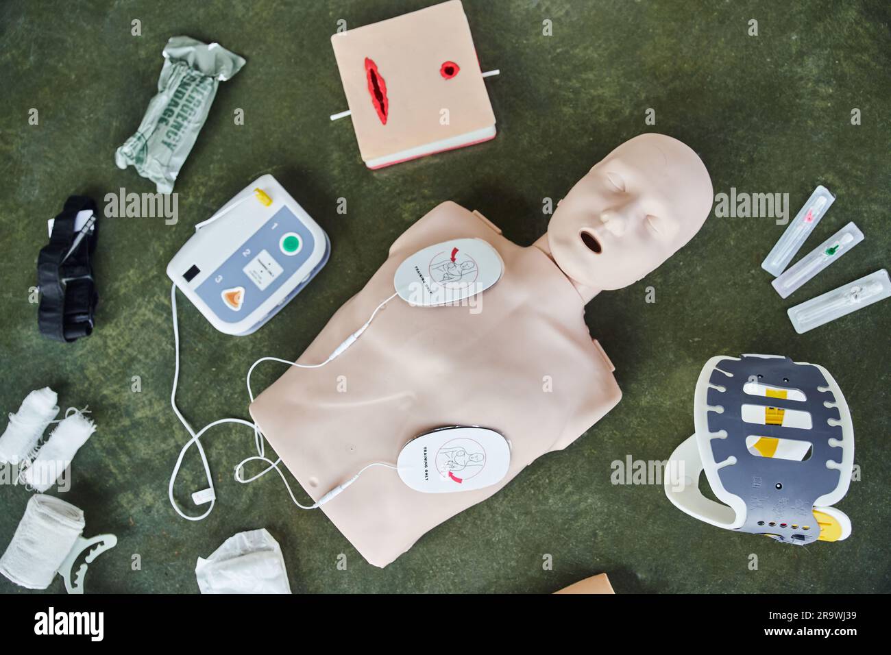 top view of CPR manikin, automated external defibrillator, wound care