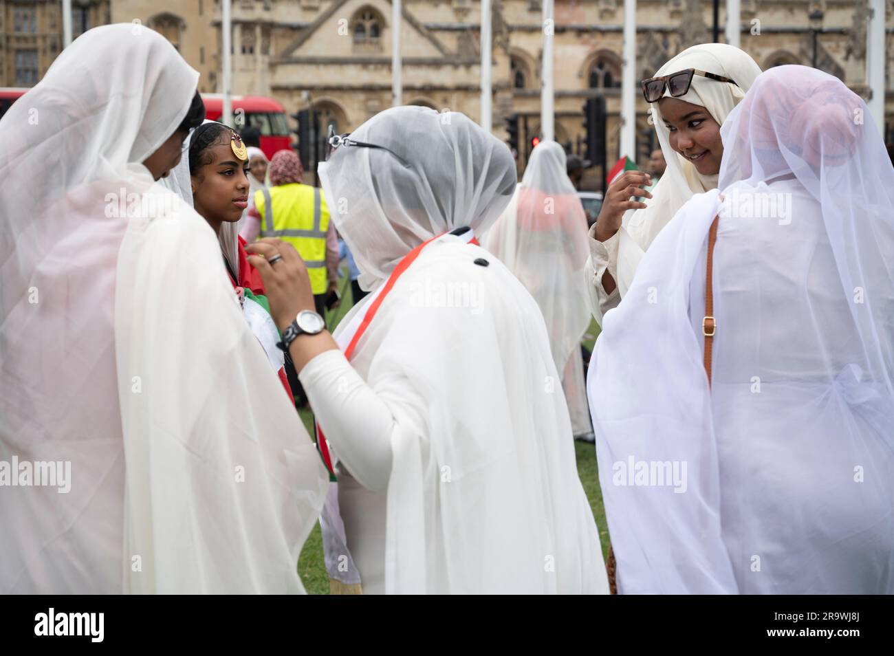Parliament Square, London. June24th 2023. Sudanese women prepare to protest against the war in Sudan and wear  special tobes, the traditional large  l Stock Photo