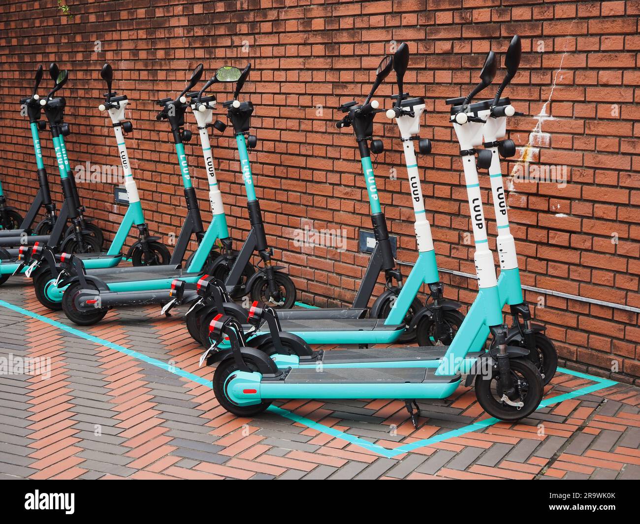 TOKYO, JAPAN - June 14, 2023: A row of Luup rental e-scooters in Yebisu Garden Place in Ebisu. Stock Photo