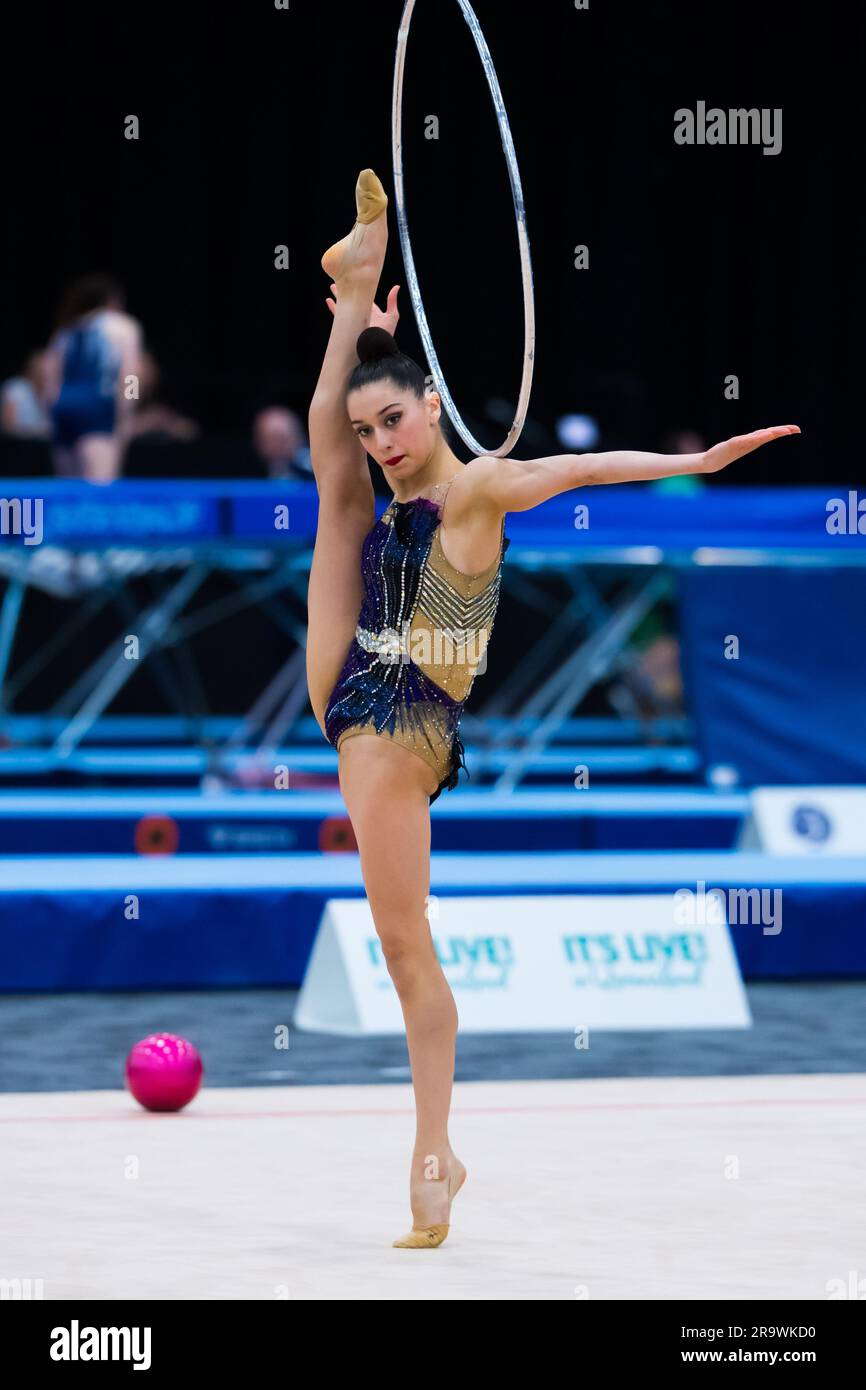 Australian Senior International Rhythmic Gymnast from NSW, Asya Seker, is rolling hoop along her arm while balancing in a vertical split during 2023 Australian Gymnastics Championships. Day 1 of the Australian Gymnastics Championship 2023, Gold Coast, Australia. Senior International Rhythmic Gymnastics session of the competition. Stock Photo