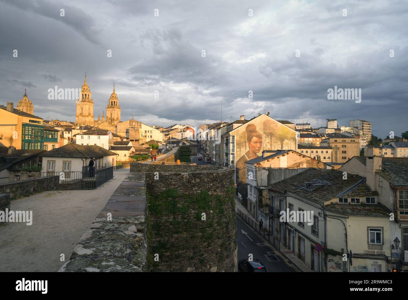 Roman wall with the cathedral in the background and the mural of a Celtic warrior in Lugo, Galicia Stock Photo